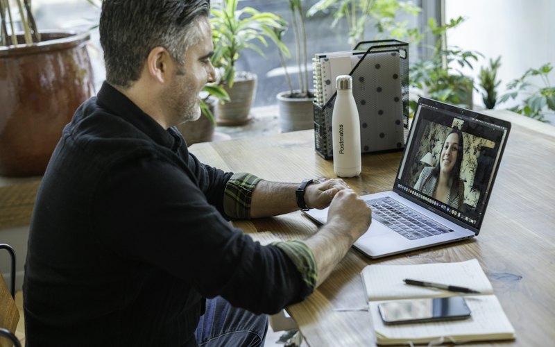 A man on a video call at his laptop